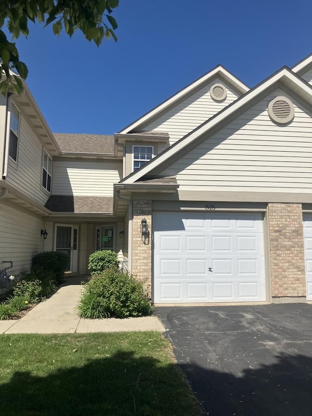 1926 Grove Ave, Schaumburg, IL 60193 - view of front of property with brick siding, asphalt driveway, and a garage