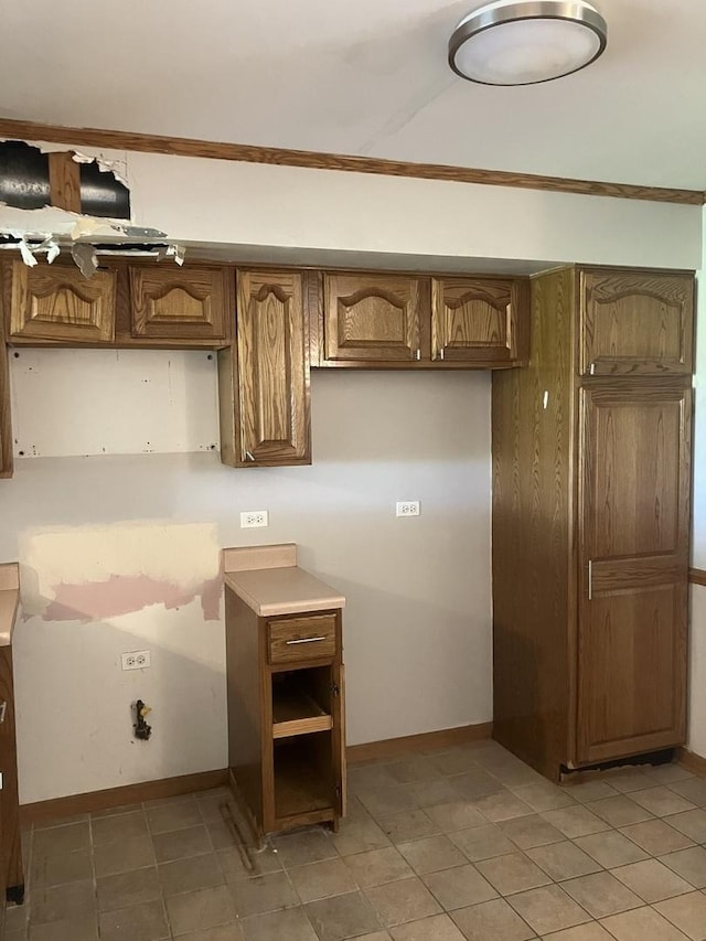 1926 Grove Ave, Schaumburg, IL 60193 - kitchen featuring crown molding, light tile patterned flooring, baseboards, and brown cabinets