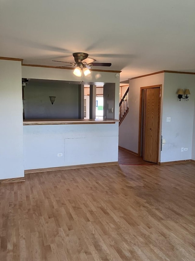 1926 Grove Ave, Schaumburg, IL 60193 - unfurnished living room with a ceiling fan, wood finished floors, baseboards, ornamental molding, and stairway