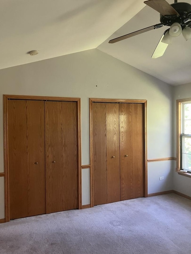 1926 Grove Ave, Schaumburg, IL 60193 - unfurnished bedroom featuring multiple closets, lofted ceiling, carpet floors, baseboards, and a ceiling fan