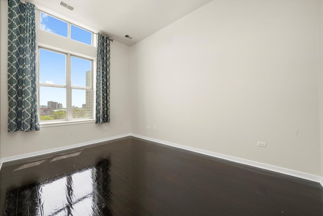 1935 S Archer Ave Unit 622, Chicago, IL 60616 - empty room featuring dark wood-style flooring, baseboards, plenty of natural light, and vaulted ceiling