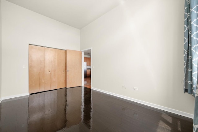 1935 S Archer Ave Unit 622, Chicago, IL 60616 - unfurnished bedroom featuring baseboards, dark wood finished floors, and a closet