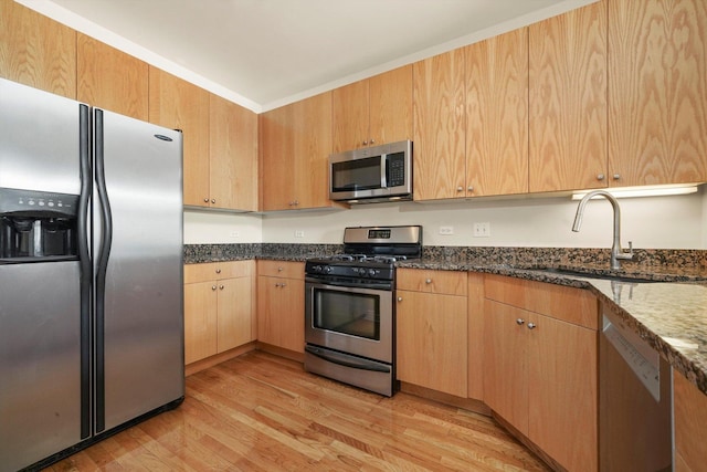 1935 S Archer Ave Unit 622, Chicago, IL 60616 - kitchen featuring stainless steel appliances, light wood-style flooring, dark stone countertops, a sink, and light brown cabinets