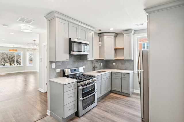 7801 S Honore St, Chicago, IL 60620 - kitchen with appliances with stainless steel finishes, gray cabinetry, a sink, plenty of natural light, and recessed lighting
