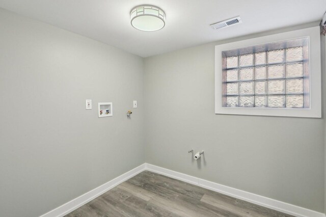 7801 S Honore St, Chicago, IL 60620 - laundry area with hookup for a gas dryer, hookup for a washing machine, wood finished floors, and baseboards