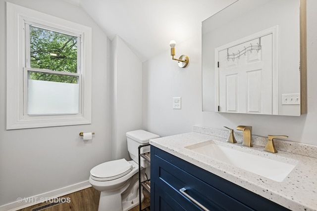 374 E Crystal Lake Ave, Crystal Lake, IL 60014 - bathroom with vanity, toilet, wood finished floors, vaulted ceiling, and baseboards