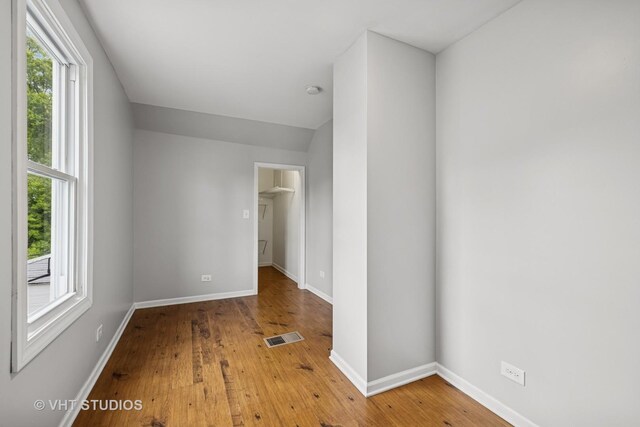 374 E Crystal Lake Ave, Crystal Lake, IL 60014 - unfurnished bedroom featuring hardwood / wood-style flooring, baseboards, a walk in closet, and a closet