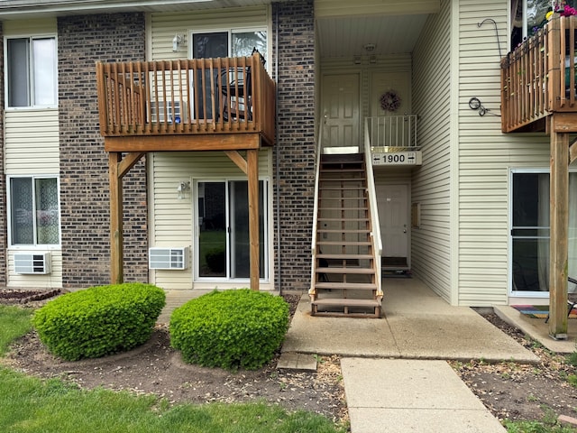 1900 Light Rd Unit 111, Oswego, IL 60543 - entrance to property with brick siding, a balcony, and cooling unit