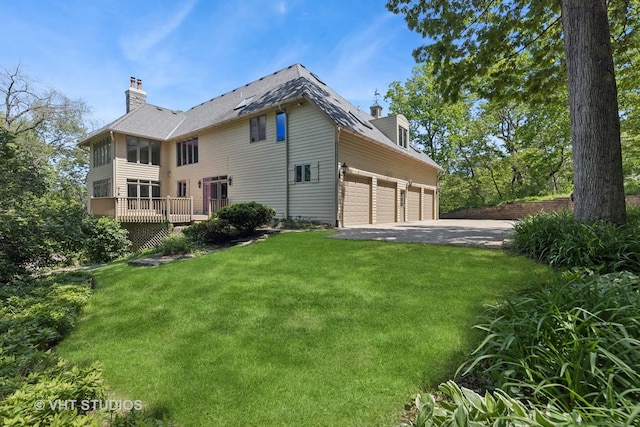 41W180 Highwood Ct, Elburn, IL 60119 - back of house featuring a chimney, asphalt driveway, a yard, and a garage