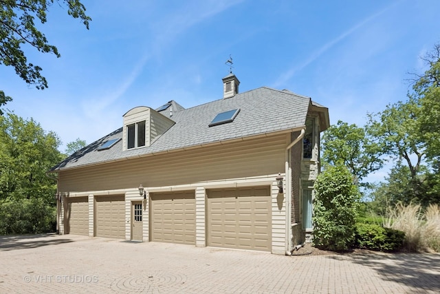 41W180 Highwood Ct, Elburn, IL 60119 - view of side of property featuring driveway, a chimney, and a high end roof