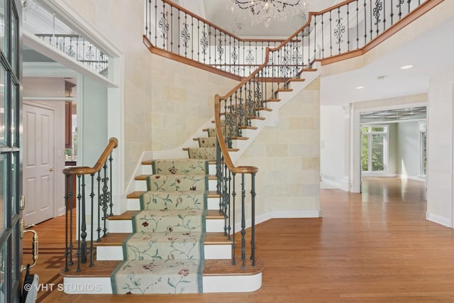 41W180 Highwood Ct, Elburn, IL 60119 - stairway with a towering ceiling, wood finished floors, and a chandelier