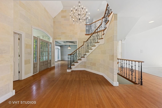 41W180 Highwood Ct, Elburn, IL 60119 - entryway featuring wood finished floors, stairs, a towering ceiling, and a chandelier