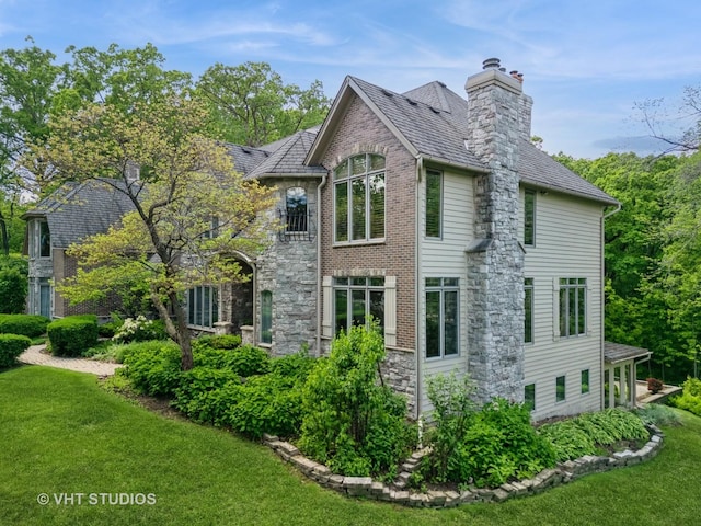 41W180 Highwood Ct, Elburn, IL 60119 - view of home's exterior with a lawn, a chimney, and stone siding