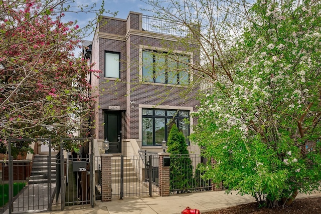 2128 N Winchester Ave, Chicago, IL 60614 - view of front of house featuring brick siding, a gate, and a fenced front yard