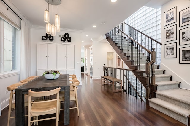 2128 N Winchester Ave, Chicago, IL 60614 - dining area with plenty of natural light, stairs, baseboards, dark wood-style flooring, and crown molding