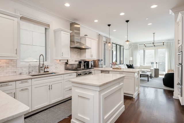 2128 N Winchester Ave, Chicago, IL 60614 - kitchen with wall chimney exhaust hood, a sink, a peninsula, open floor plan, and white cabinetry