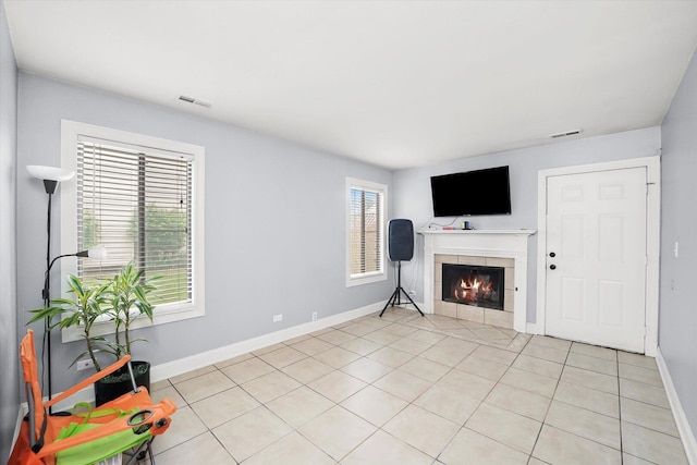 1026 Bothwell Ct, Bolingbrook, IL 60440 - unfurnished living room featuring a tile fireplace, baseboards, and light tile patterned floors