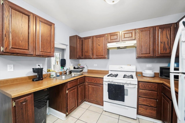 1026 Bothwell Ct, Bolingbrook, IL 60440 - kitchen with white range with gas cooktop, under cabinet range hood, a sink, a desk, and light tile patterned floors