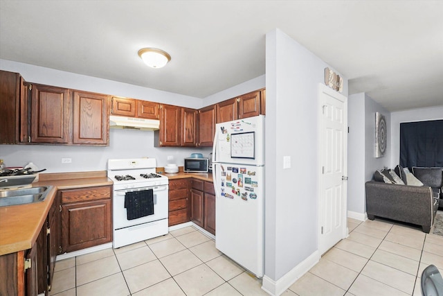 1026 Bothwell Ct, Bolingbrook, IL 60440 - kitchen featuring white appliances, under cabinet range hood, a sink, light tile patterned floors, and light countertops