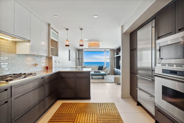 3200 N Lake Shore Dr Unit 2905, Chicago, IL 60657 - kitchen with built in appliances, open floor plan, decorative backsplash, light countertops, and light tile patterned flooring