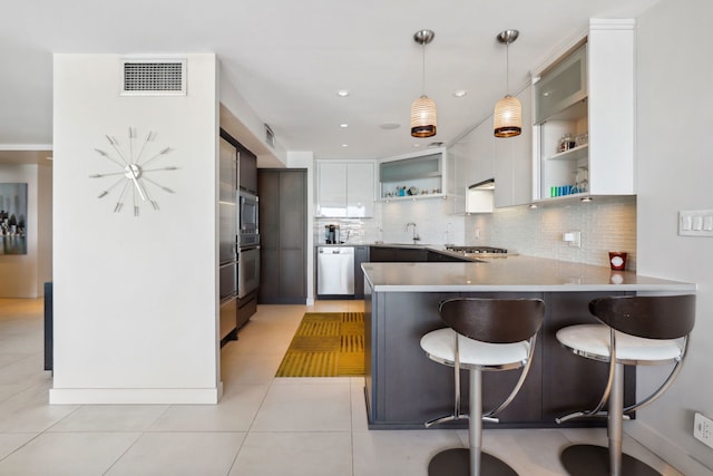 3200 N Lake Shore Dr Unit 2905, Chicago, IL 60657 - kitchen featuring open shelves, a sink, stainless steel appliances, tasteful backsplash, and a peninsula