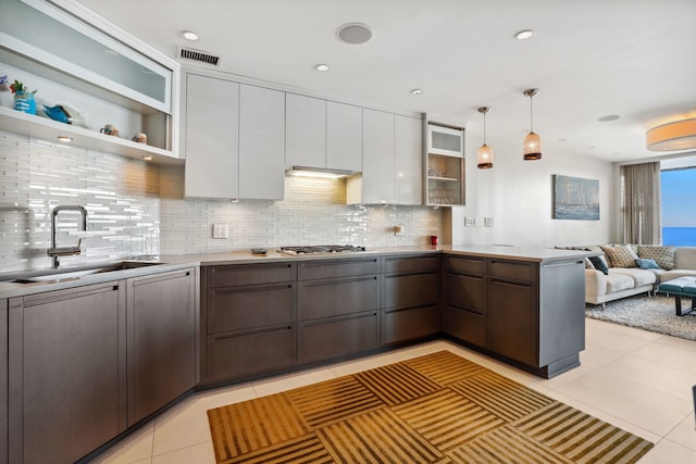 3200 N Lake Shore Dr Unit 2905, Chicago, IL 60657 - kitchen with open shelves, a sink, tasteful backsplash, a peninsula, and light tile patterned floors