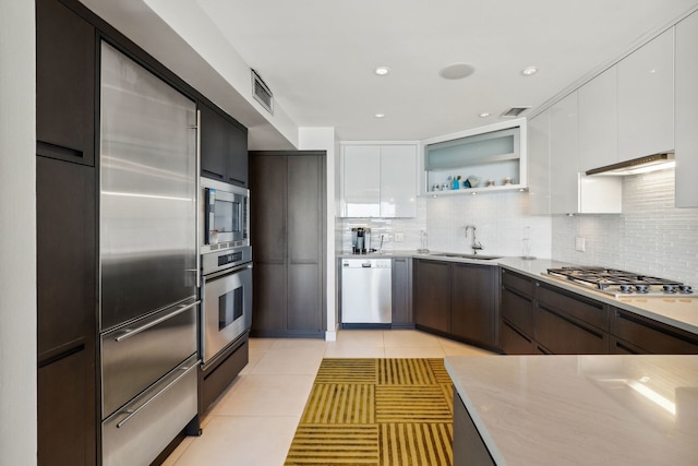 3200 N Lake Shore Dr Unit 2905, Chicago, IL 60657 - kitchen featuring built in appliances, a sink, light tile patterned floors, backsplash, and recessed lighting