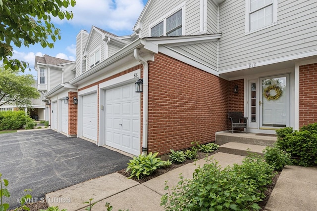 818 Kalamazoo Cir, Vernon Hills, IL 60061 - doorway to property featuring brick siding and asphalt driveway
