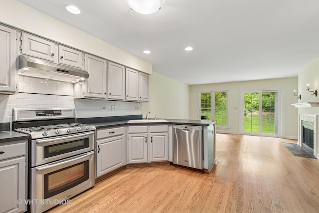 818 Kalamazoo Cir, Vernon Hills, IL 60061 - kitchen featuring under cabinet range hood, appliances with stainless steel finishes, dark countertops, a sink, and recessed lighting