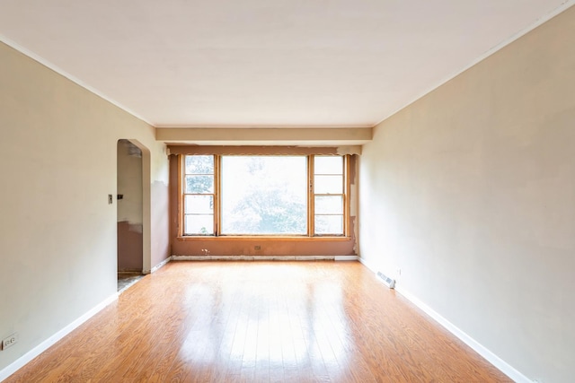 4224 W 109th St, Oak Lawn, IL 60453 - spare room featuring arched walkways, light wood-style flooring, baseboards, and crown molding