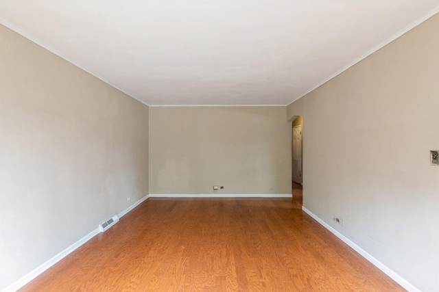 4224 W 109th St, Oak Lawn, IL 60453 - unfurnished room with light wood-type flooring, arched walkways, baseboards, and ornamental molding
