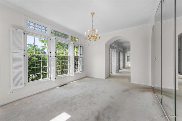 324 Torrington Dr, Bloomingdale, IL 60108 - unfurnished dining area featuring ornamental molding, arched walkways, carpet flooring, a chandelier, and baseboards