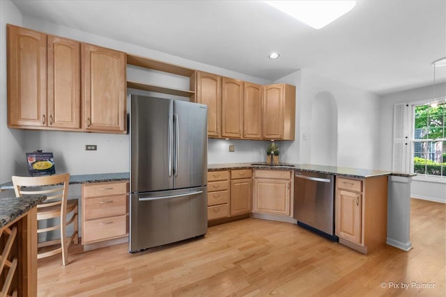 324 Torrington Dr, Bloomingdale, IL 60108 - kitchen with appliances with stainless steel finishes, light wood-style floors, a peninsula, dark stone countertops, and recessed lighting