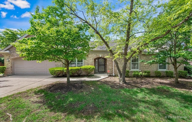 324 Torrington Dr, Bloomingdale, IL 60108 - obstructed view of property with concrete driveway, an attached garage, and brick siding