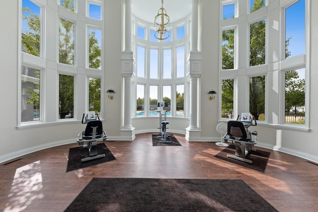 324 Torrington Dr, Bloomingdale, IL 60108 - exercise room featuring decorative columns, a high ceiling, dark wood finished floors, and baseboards