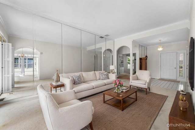 324 Torrington Dr, Bloomingdale, IL 60108 - living area featuring ornamental molding, arched walkways, and a chandelier