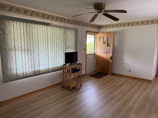 318 Durant St, Oglesby, IL 61348 - foyer entrance with ceiling fan, wood finished floors, and baseboards