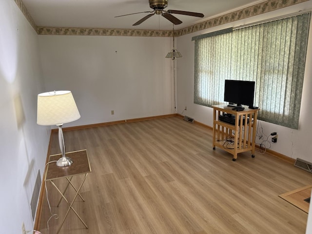 318 Durant St, Oglesby, IL 61348 - unfurnished office featuring a ceiling fan, light wood-type flooring, and baseboards