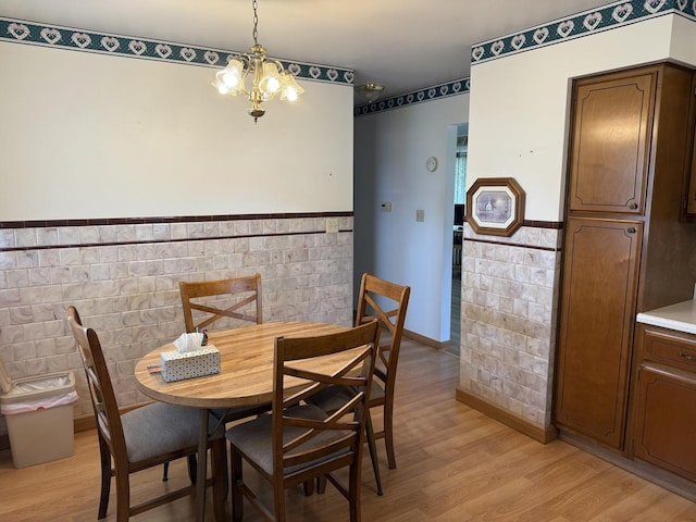 318 Durant St, Oglesby, IL 61348 - dining space with wainscoting, light wood-type flooring, a chandelier, and tile walls