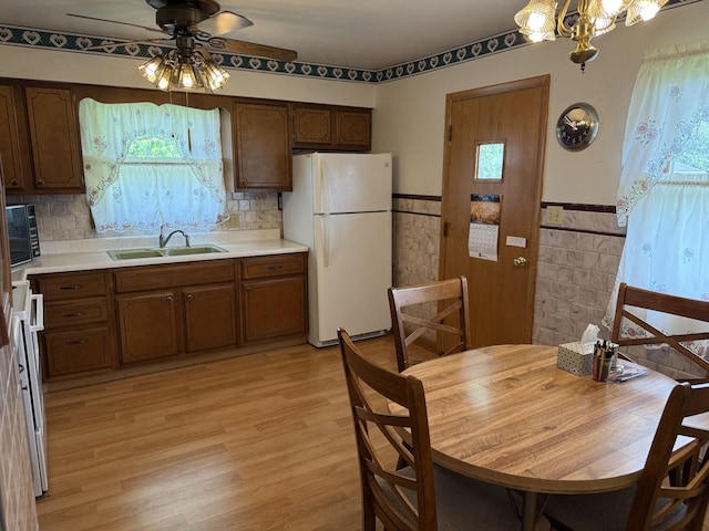 318 Durant St, Oglesby, IL 61348 - kitchen with freestanding refrigerator, a sink, ceiling fan, healthy amount of natural light, and a wainscoted wall