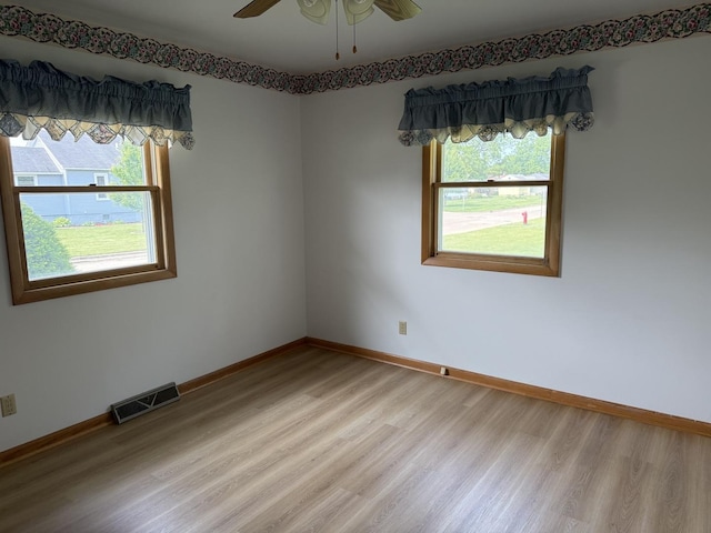 318 Durant St, Oglesby, IL 61348 - empty room with light wood-style flooring, healthy amount of natural light, baseboards, and ceiling fan