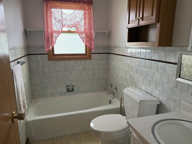 318 Durant St, Oglesby, IL 61348 - bathroom featuring toilet, a tub to relax in, vanity, tile patterned floors, and tile walls