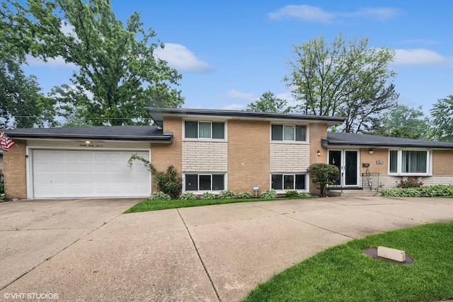 9047 Crawford Ave, Skokie, IL 60076 - tri-level home featuring brick siding, driveway, a garage, and french doors
