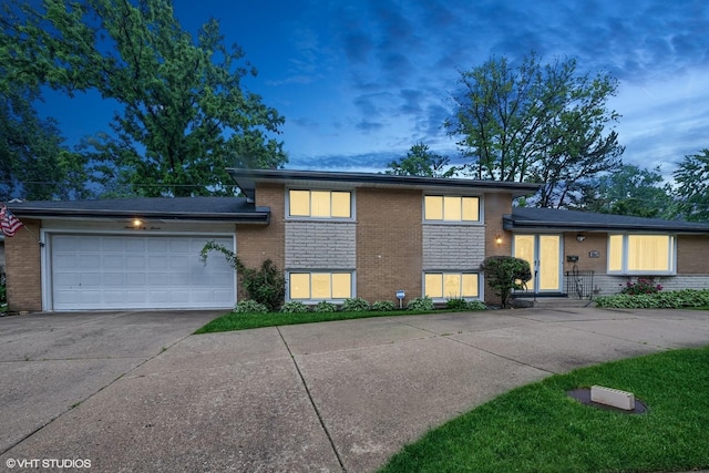 9047 Crawford Ave, Skokie, IL 60076 - tri-level home with brick siding, concrete driveway, and a garage