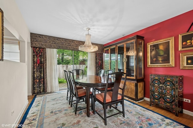 9047 Crawford Ave, Skokie, IL 60076 - dining area featuring a chandelier, baseboards, and wood finished floors