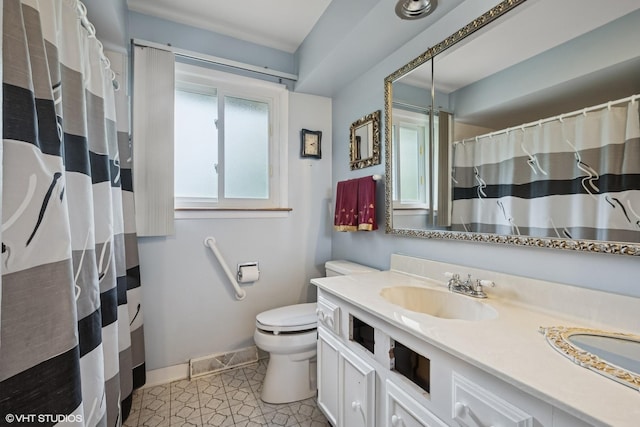 9047 Crawford Ave, Skokie, IL 60076 - full bath featuring vanity, toilet, baseboards, and tile patterned flooring