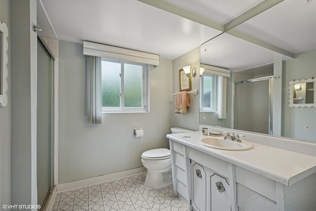 9047 Crawford Ave, Skokie, IL 60076 - bathroom with a shower stall, baseboards, toilet, vanity, and tile patterned floors