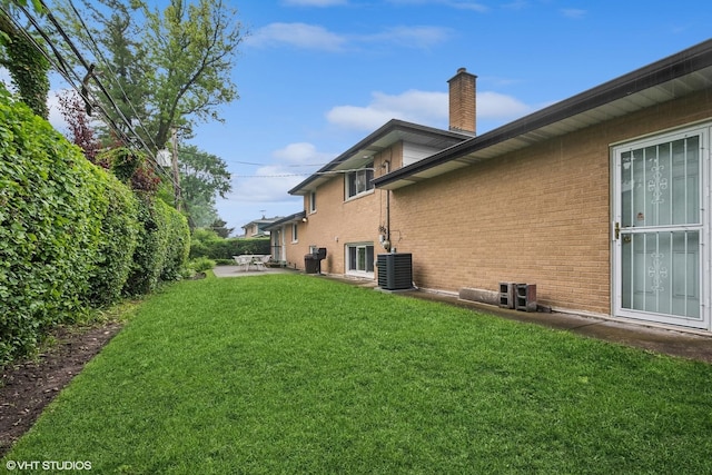 9047 Crawford Ave, Skokie, IL 60076 - view of green lawn with central AC and a patio