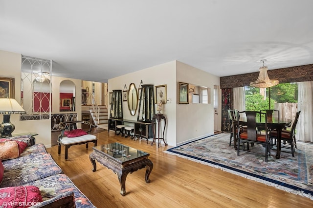 9047 Crawford Ave, Skokie, IL 60076 - living area with stairway, wood finished floors, arched walkways, and baseboards