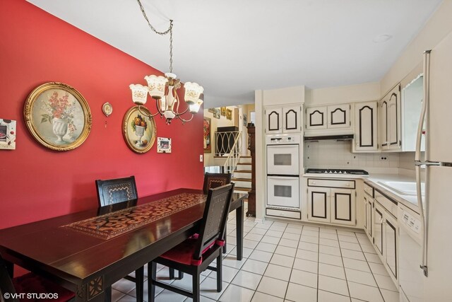 9047 Crawford Ave, Skokie, IL 60076 - kitchen featuring white appliances, a chandelier, light countertops, backsplash, and pendant lighting